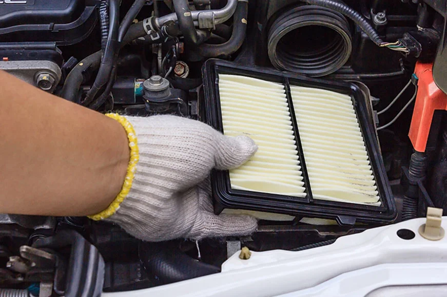 Certified Maintenance Technician is replacing an air filter for a GMC SUV